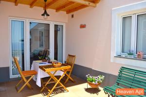 a patio with a table and chairs on a balcony at Villa Henriques in Funchal