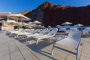 a row of lounge chairs and umbrellas on a patio at Gloria Palace Royal Hotel & Spa in Puerto Rico de Gran Canaria