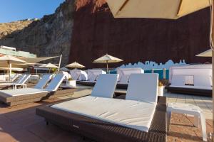 a group of chairs and umbrellas on a patio at Gloria Palace Royal Hotel & Spa in Puerto Rico de Gran Canaria