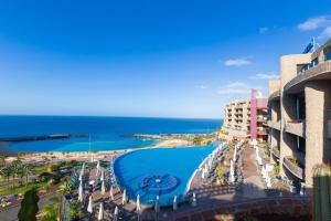 a view of a resort with a swimming pool and the ocean at Gloria Palace Royal Hotel & Spa in Puerto Rico de Gran Canaria