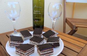 a table with two glasses of wine and chocolate cakes at Apartmani Marin in Vrbnik