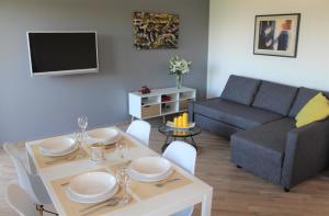 a living room with a table and a couch at Apartmani Marin in Vrbnik