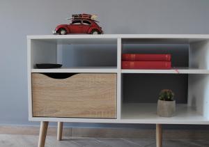 a white book shelf with a red car on it at Apartmani Marin in Vrbnik