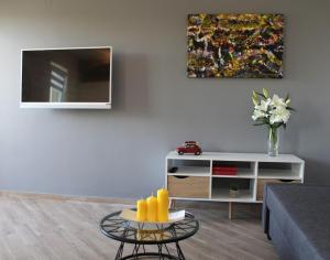 a living room with a couch and a table at Apartmani Marin in Vrbnik