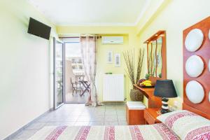 a bedroom with a bed and a balcony at Casa Di Mare in Olympiaki Akti