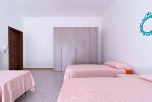 TrepuzziにあるLa Terraのピンクのシーツが備わるベッド2台付きの部屋