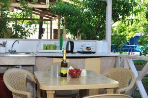 a table with a bottle of wine on a patio at Veranda in Karolino-Buhaz