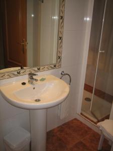 a bathroom with a sink and a shower at Hotel Chané in Puebla de Alfindén