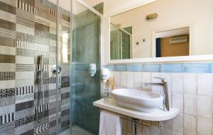 a bathroom with a sink and a shower at Hotel Corallo in Pomonte