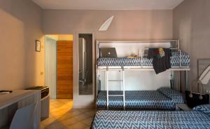 a bedroom with two bunk beds with a laptop on it at Hotel Corallo in Pomonte