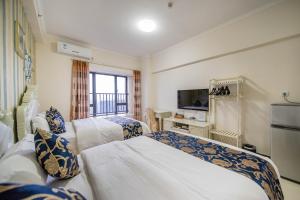 Kama o mga kama sa kuwarto sa Xing Yu Legend Service Apartment Canton Fair Branch