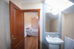 a bathroom with a sink and a mirror at As Viñas in Viveiro +28 photos