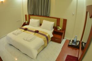 Postel nebo postele na pokoji v ubytování Bahla Jewel Hotel Apartments
