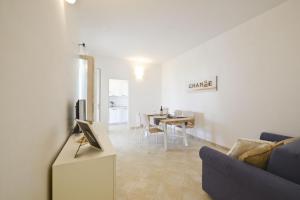 a living room with a couch and a table at Blue Sea Villas by Wonderful Italy in Ostuni