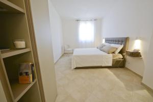 Un ou plusieurs lits dans un hébergement de l'établissement Blue Sea Villas by Wonderful Italy