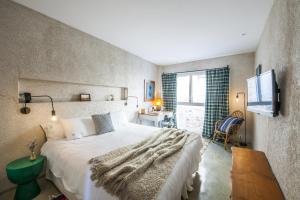 a bedroom with a large bed and a window at Kook Hotel Tarifa in Tarifa