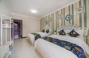 Kama o mga kama sa kuwarto sa Xing Yu Legend Service Apartment Canton Fair Branch