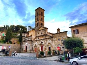 an old stone building with a clock tower at Casa Mirella in Bolsena