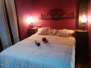 a bedroom with a large white bed with flowers on it at Carpe Diem in Navaridas