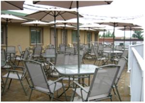 a group of tables and chairs with umbrellas at Motel Du Parc Masson in Gatineau