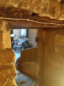 a view of a stone building with a cannon in the background at Carpe Diem in Navaridas