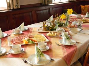 einen Tisch mit Teller mit Speisen darüber in der Unterkunft Ferienwohnungen Hotel Garni Dörflerwirt in Aflenz Kurort