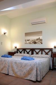 a bedroom with two beds with blue towels on them at La Azacaya in Baeza