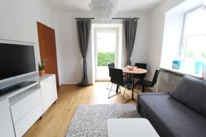 a living room with a couch and a table with chairs at Haus Anneliese in Bad Reichenhall