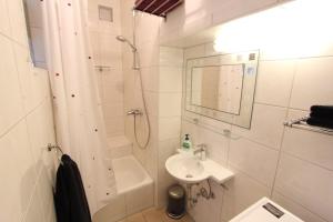 a white bathroom with a sink and a shower at Haus Anneliese in Bad Reichenhall