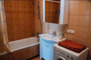 a bathroom with a sink and a washing machine at New apartament very close to the city centre in Vilnius +38 photos