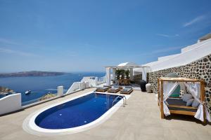 a villa with a swimming pool with a view of the ocean at Volcano View by Caldera Collection in Fira