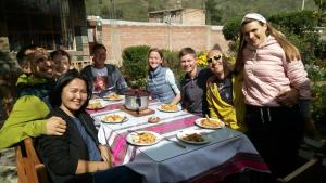 a group of people sitting around a table eating food at Los Geranios in Yanque