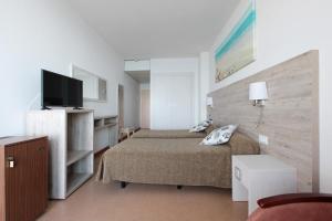 a bedroom with a bed and a flat screen tv at Hotel Maria Teresa in Sant Antoni de Calonge