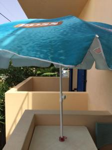 a blue umbrella sitting on top of a box at Eugenia travasarou sea view appartments in Diakofti