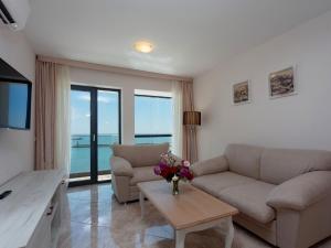 a living room with a couch and a table at Antik Apartments in Balchik