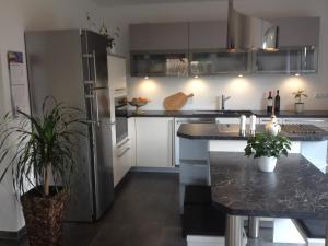 a kitchen with a stainless steel refrigerator and a counter at Ferienhaus Frankstraße 5b in Zinnowitz