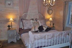 a bedroom with a white bed with pillows at Romantica Exotica in Biron