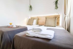 ein Hotelzimmer mit 2 Betten und Handtüchern darauf in der Unterkunft Letmalaga Sweet Family in Málaga