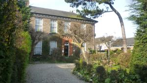 an old brick house with a garden in front of it at Holly Lodge in York