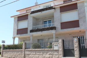 a house with a fence in front of it at Casa Artemia in Sanxenxo