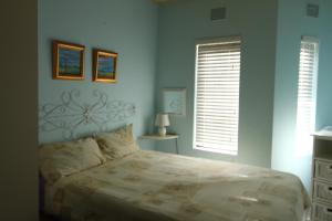 a bedroom with a large bed and two windows at Seeskulp 10 in Margate