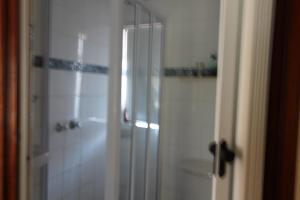 a bathroom with a shower and a toilet and a sink at Seeskulp 10 in Margate +5 photos