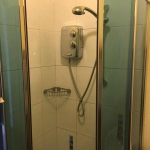a shower with a shower head in a bathroom at Sea View Guest House in Hartlepool