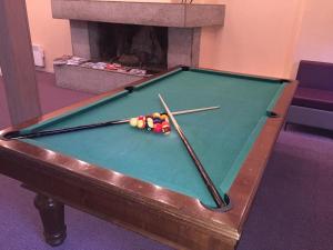 a pool table with cue balls on top of it at Hôtel Des Princes in Amphion les Bains