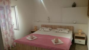a bedroom with a bed with two towels on it at Apartman Andrea in Korčula