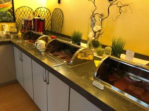 
a kitchen counter filled with lots of food at Ringhotel Altstadt in Güstrow
