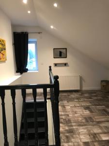 a room with a staircase and a window at O' li douillet in Les Épesses