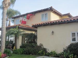 a house with a palm tree in front of it at Old Town Inn in San Diego