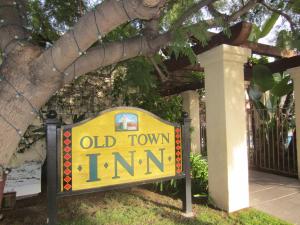 an old town inn sign in front of a fence at Old Town Inn in San Diego