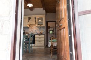 a kitchen with white cabinets and a table with chairs at Casa brillocco Castellabate in Montecorice